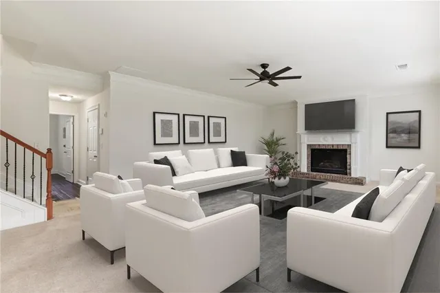 a living room with furniture a flat screen tv and a fireplace