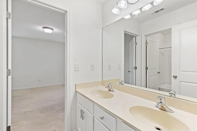 a bathroom with a sink double vanity and a mirror