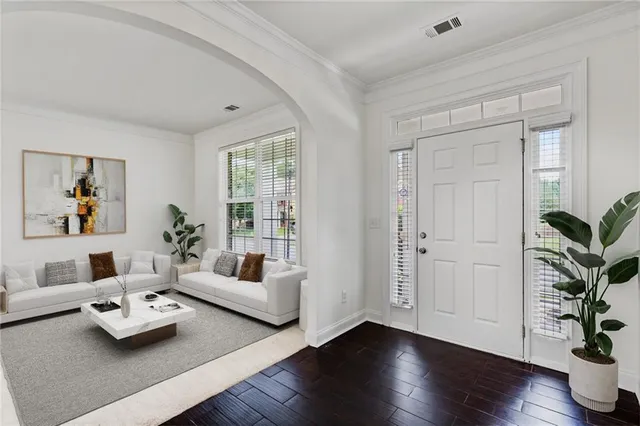 a living room with furniture and a potted plant