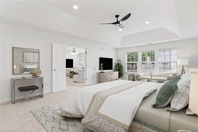 a bedroom with a bed and a large window