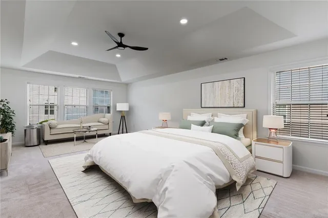 a bedroom with bed couch and window