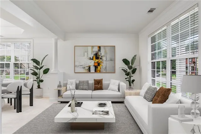 a living room with furniture and a potted plant