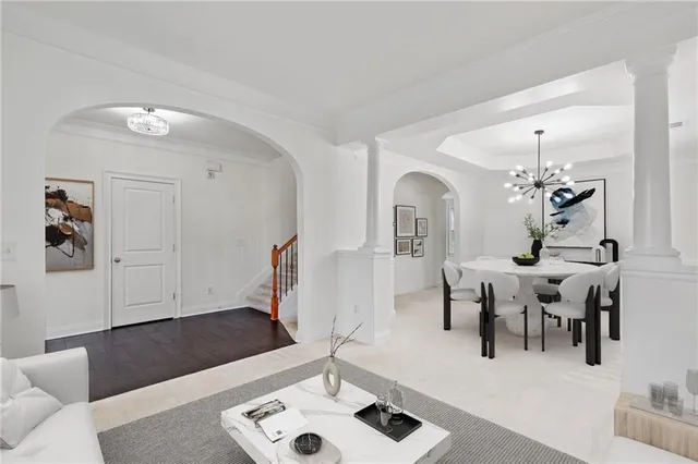 a living room with furniture a rug and white walls