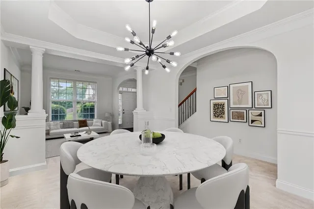 a view of a dining room with furniture and a large window