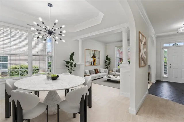 a view of a dining room with furniture and a chandelier