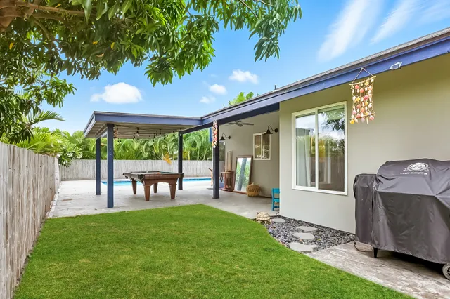 a view of a porch with furniture and garden