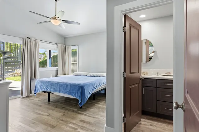 a spacious bedroom with a bed and a chandelier