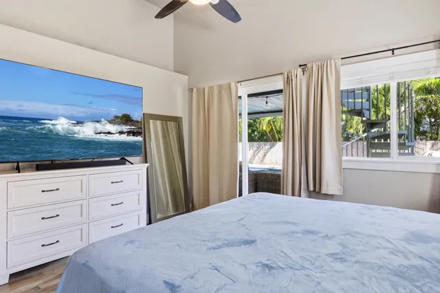 a bedroom with a large bed and a window