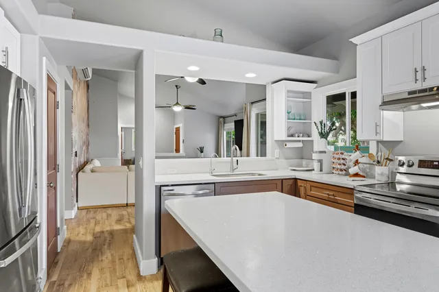 a large kitchen with kitchen island a sink appliances and cabinets