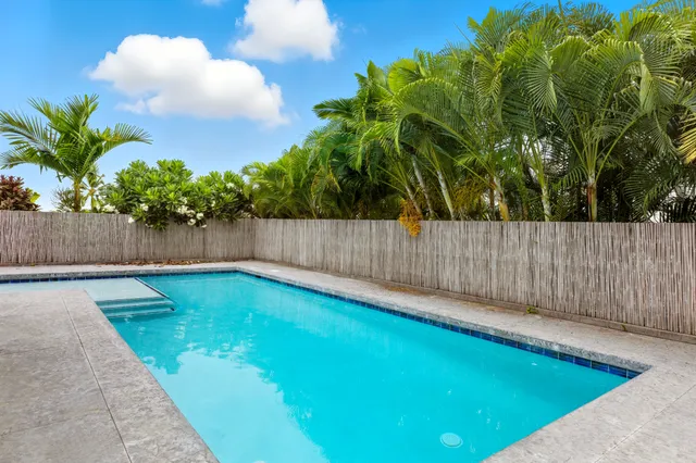 a view of outdoor space with swimming pool and wooden fence