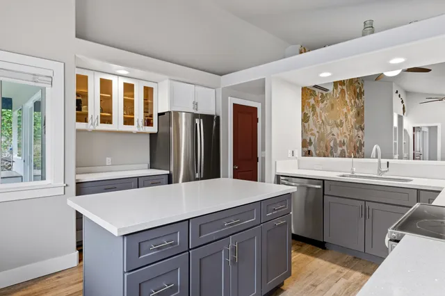 a kitchen with a sink a refrigerator and window