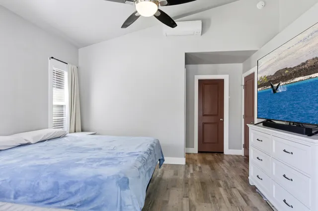 a bedroom with a bed and a dresser