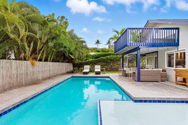 a swimming pool with outdoor seating and yard