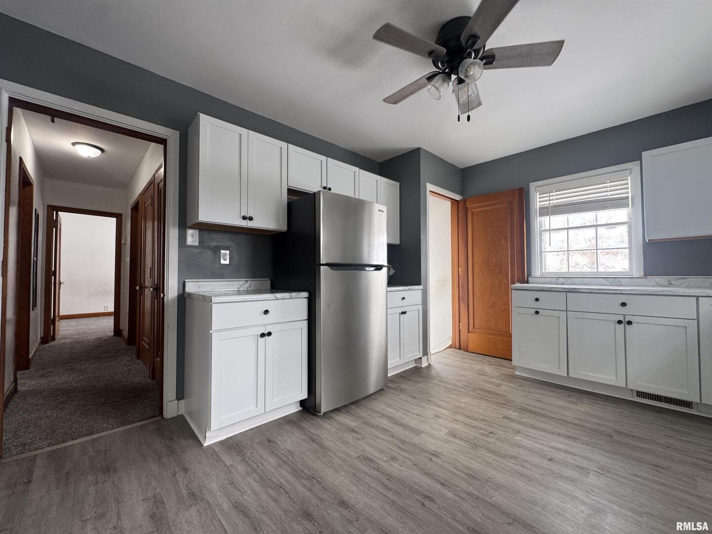 602 Washington Avenue Lowden, IA 52255 - Photo 13 of 28 a kitchen with stainless steel appliances a refrigerator sink and cabinets