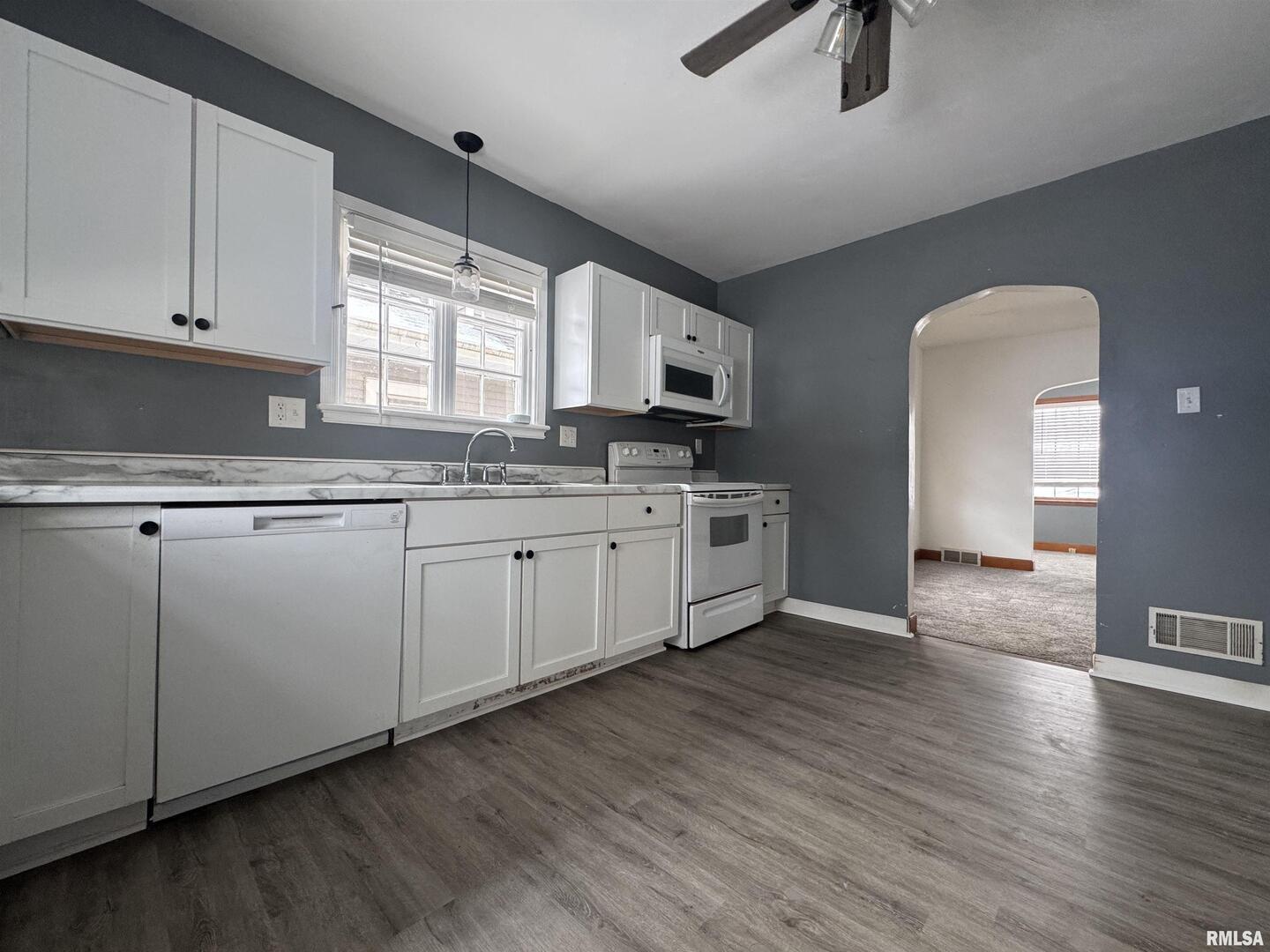 602 Washington Avenue Lowden, IA 52255 - Photo 14 of 28 a kitchen with granite countertop a sink cabinets and wooden floor