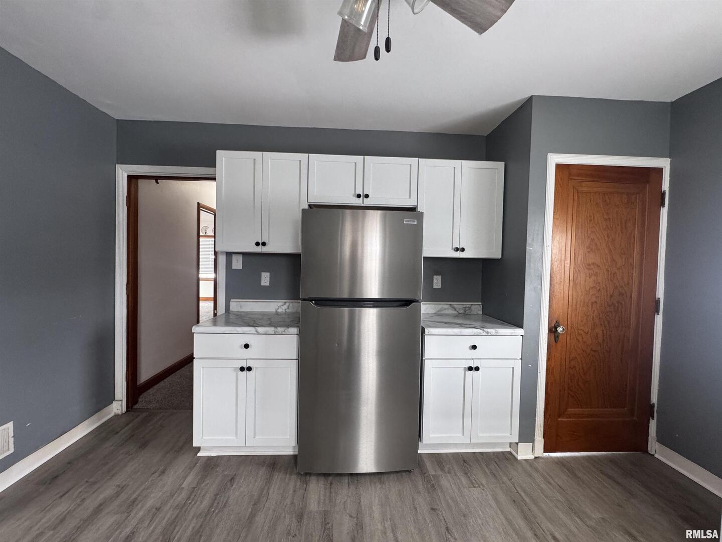 602 Washington Avenue Lowden, IA 52255 - Photo 15 of 28 a kitchen with a refrigerator and a stove top oven