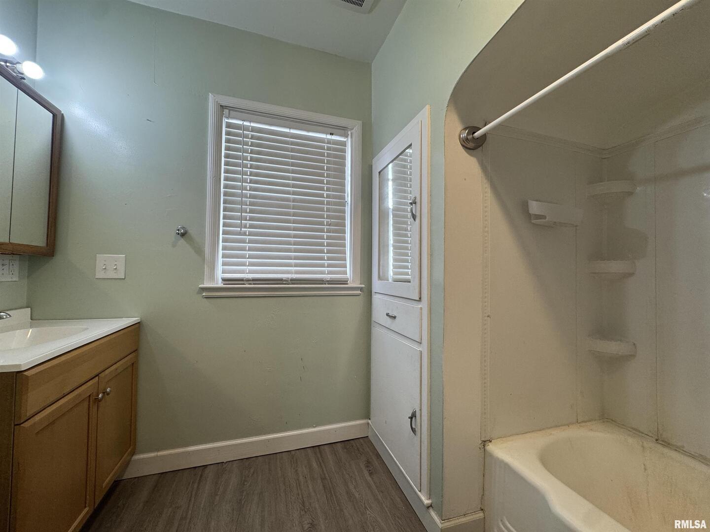 602 Washington Avenue Lowden, IA 52255 - Photo 17 of 28 a bathroom with a sink a toilet and shower