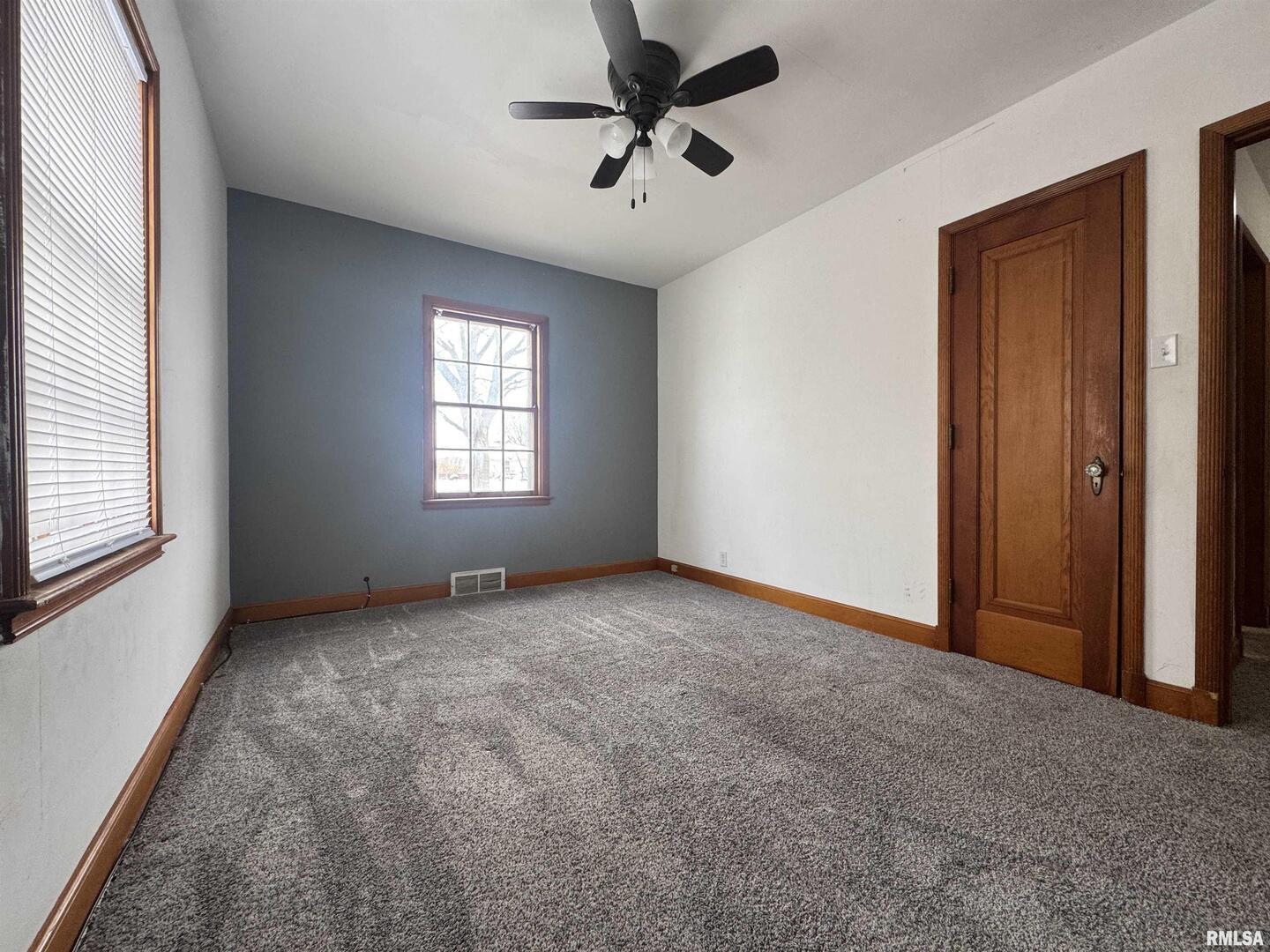 602 Washington Avenue Lowden, IA 52255 - Photo 19 of 28 a view of a livingroom with a window and a ceiling fan
