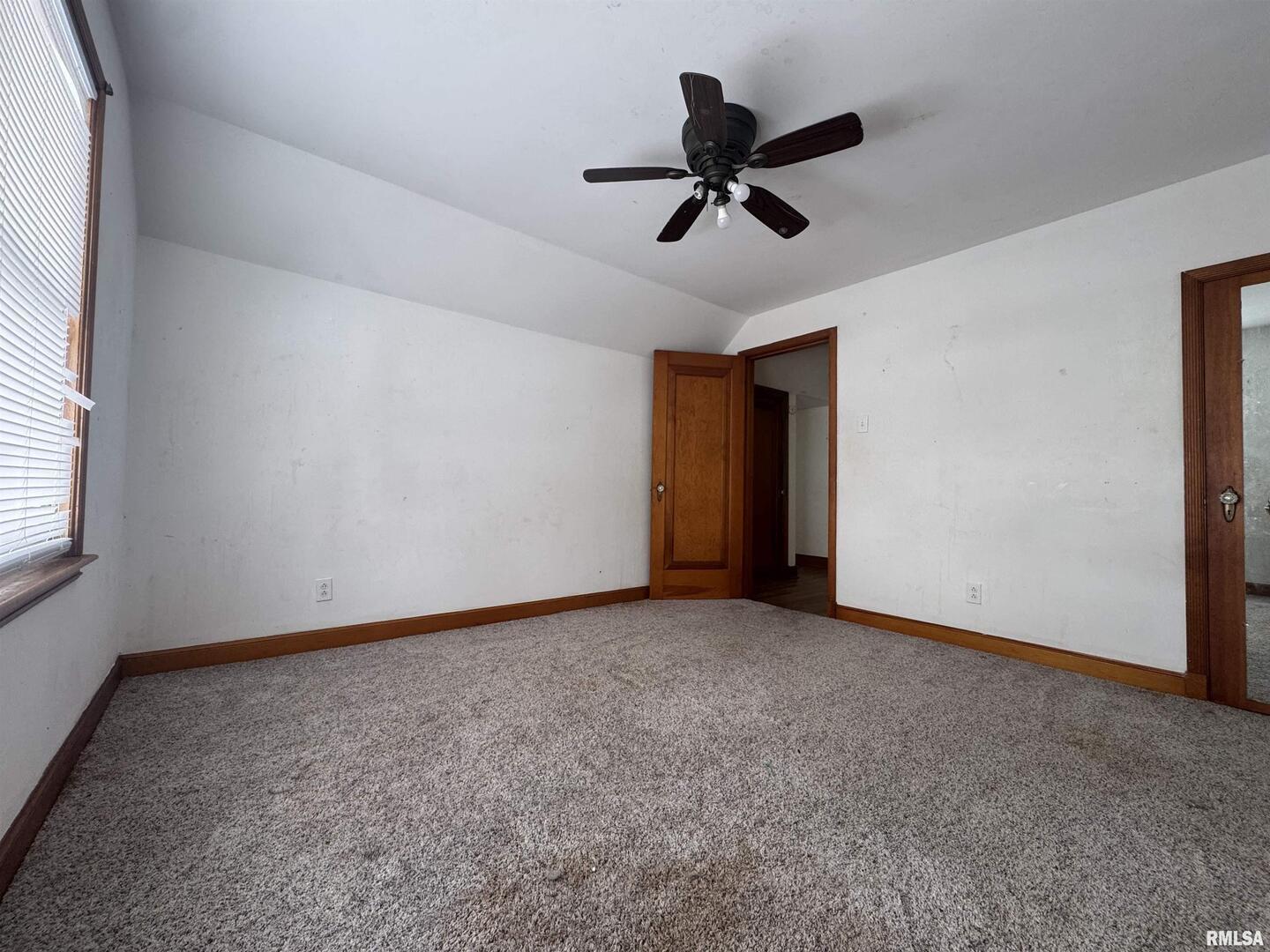 602 Washington Avenue Lowden, IA 52255 - Photo 25 of 28 a view of a livingroom with a ceiling fan and window