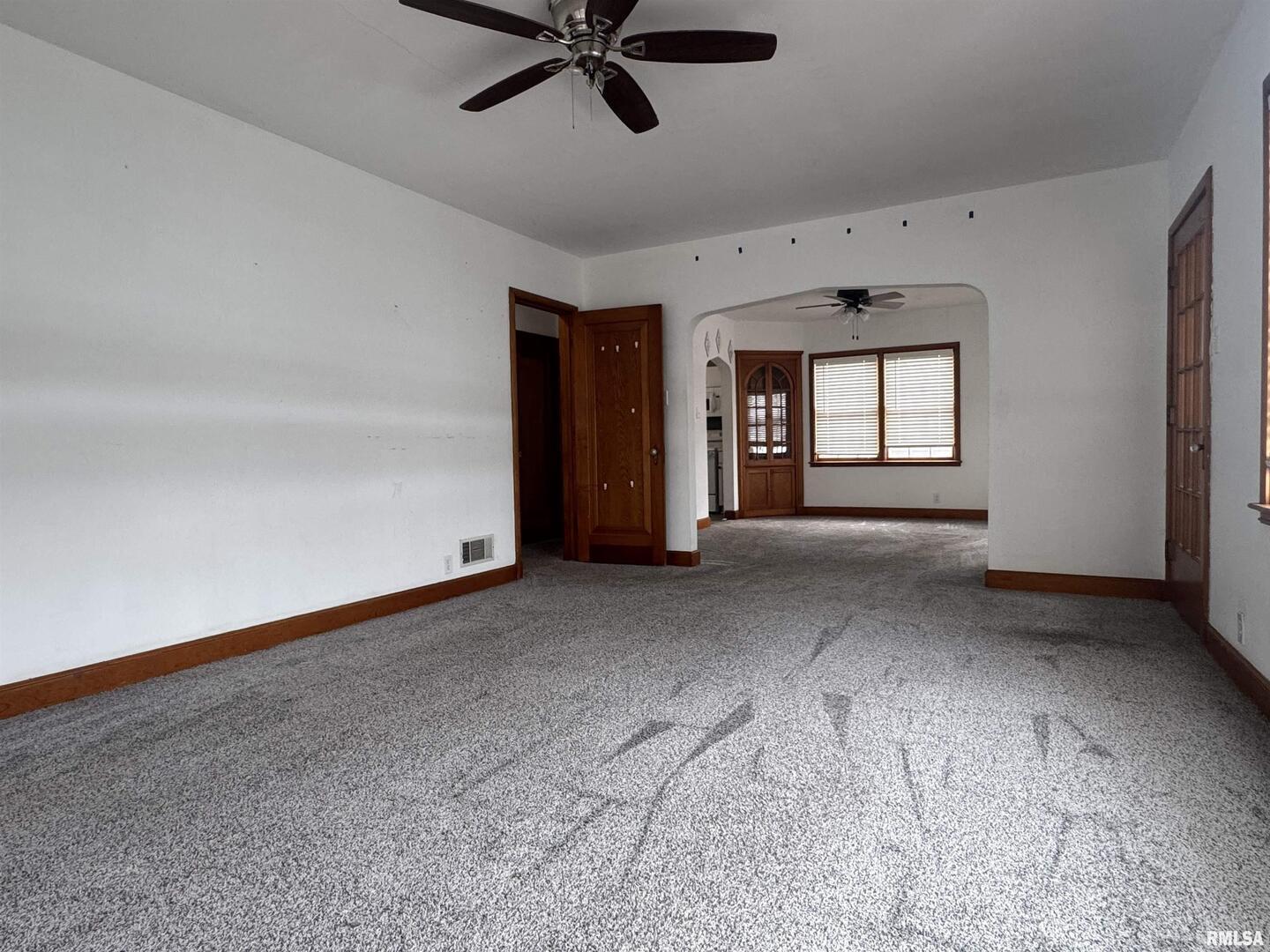 602 Washington Avenue Lowden, IA 52255 - Photo 5 of 28 a view of a livingroom with a ceiling fan and window