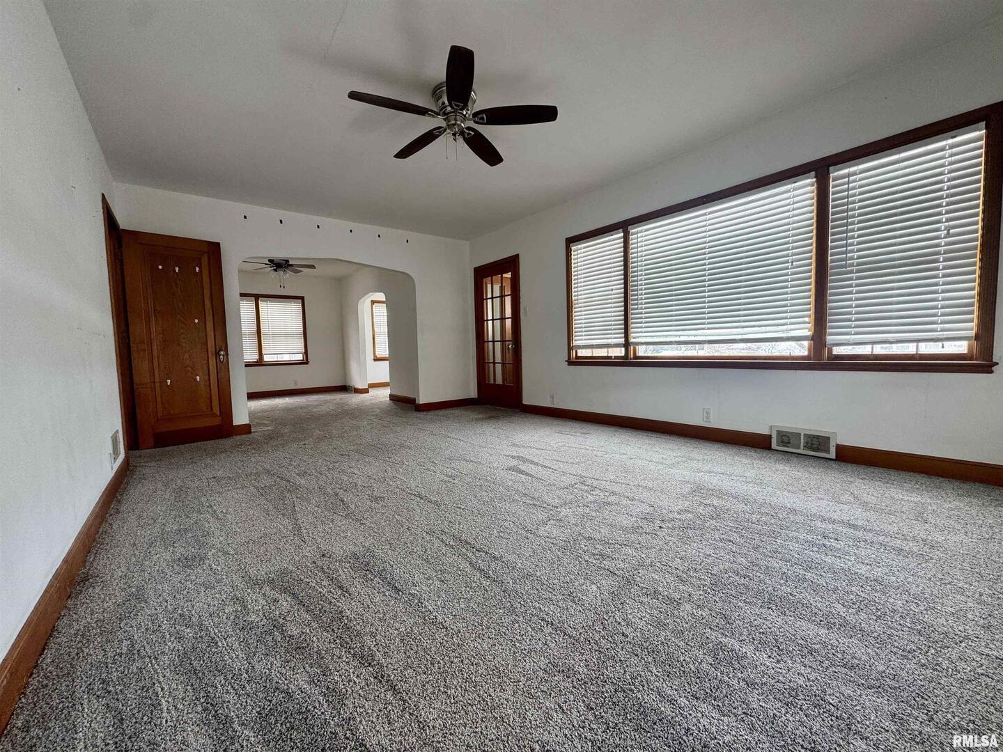 602 Washington Avenue Lowden, IA 52255 - Photo 6 of 28 a view of a livingroom with a ceiling fan and window