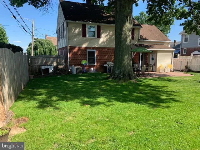 a view of a house with a yard and sitting area