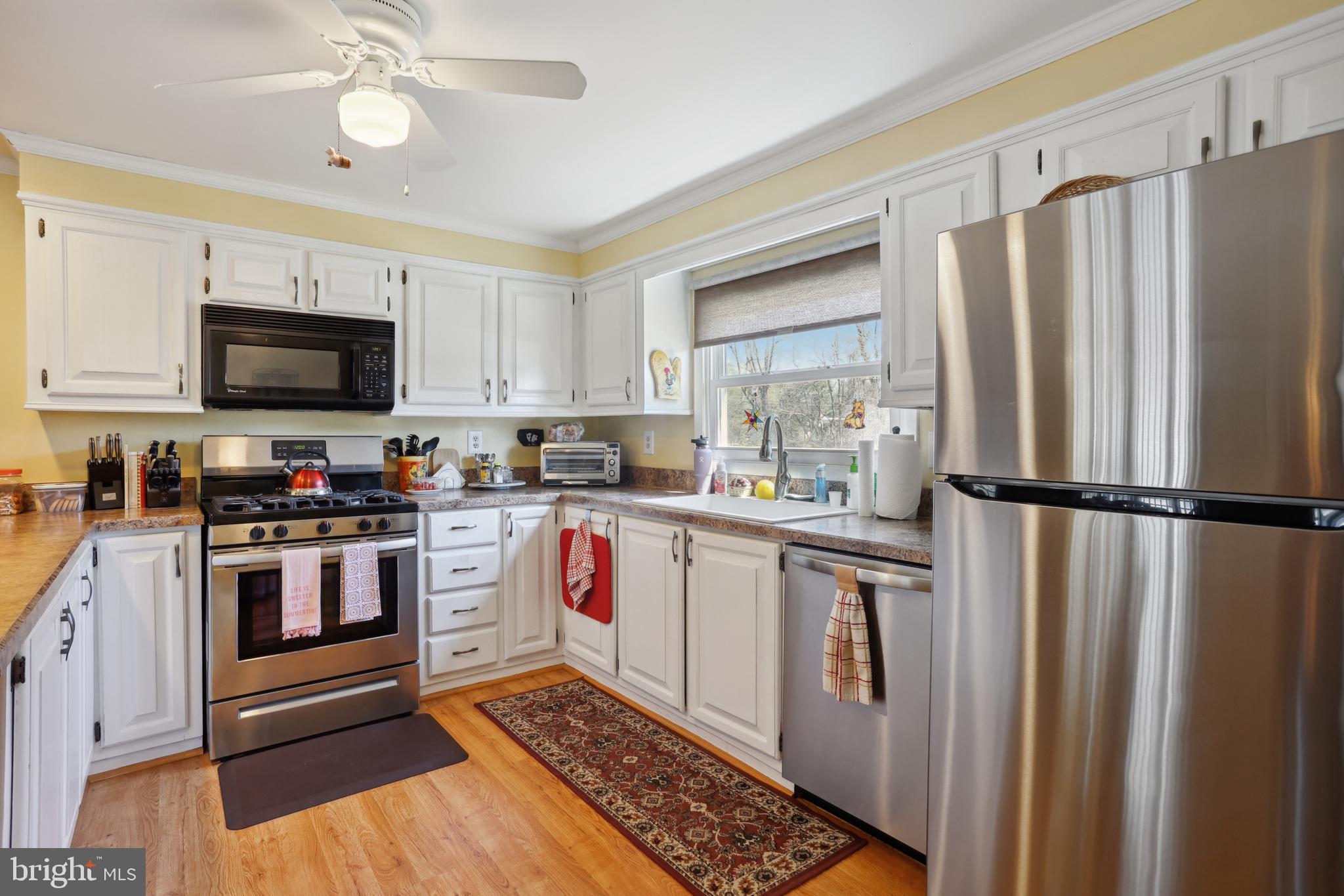 1122 Lemur Lane Mount Laurel, NJ 08054 - Photo 3 of 18 a kitchen with stainless steel appliances a refrigerator stove and microwave