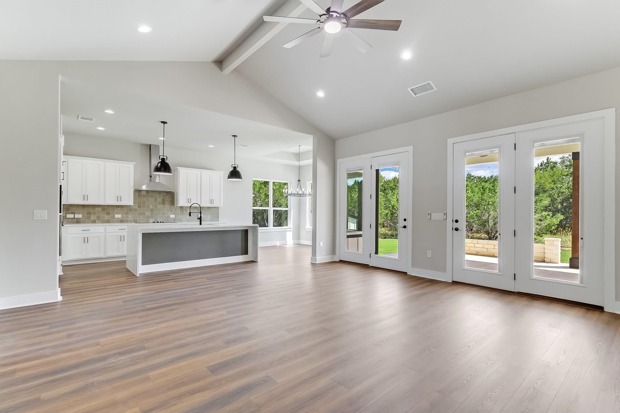 179 Rosebud Rnch Road Bertram, TX 78605 - Photo 11 of 28 a view of kitchen with window and wooden floor