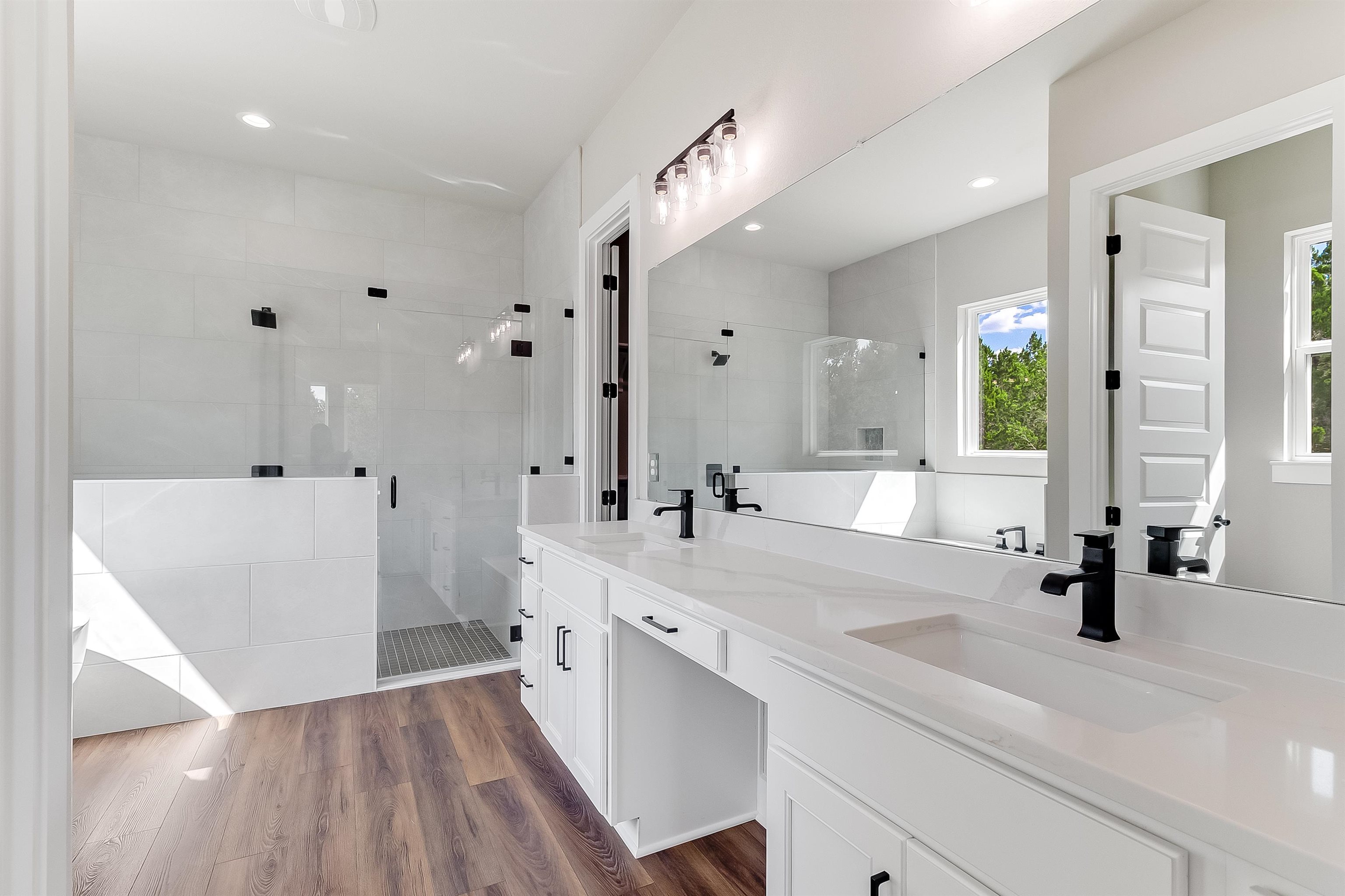 179 Rosebud Rnch Road Bertram, TX 78605 - Photo 14 of 28 a large white bathroom with a sink a large mirror and shower