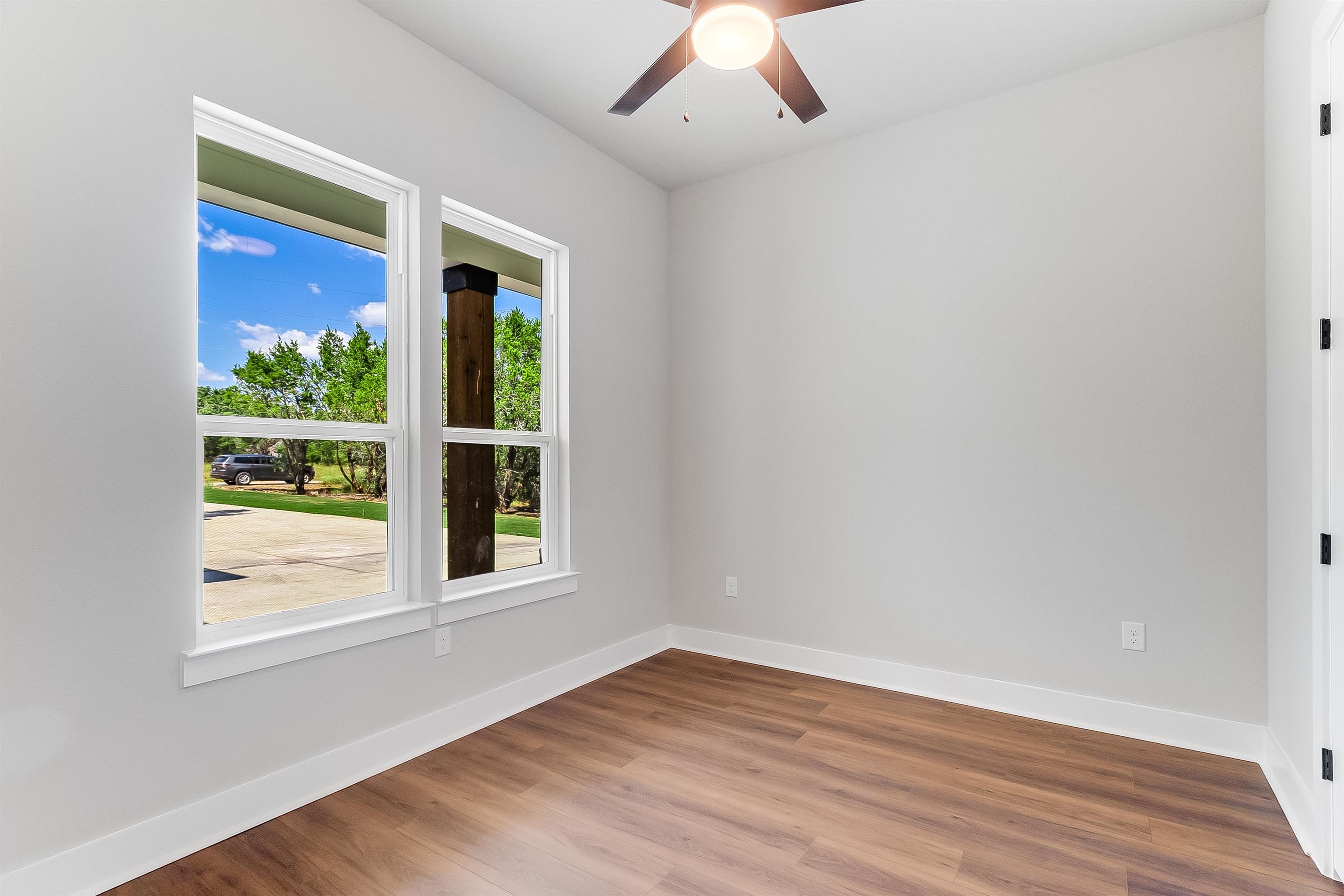 179 Rosebud Rnch Road Bertram, TX 78605 - Photo 19 of 28 a view of an empty room with wooden floor and a window