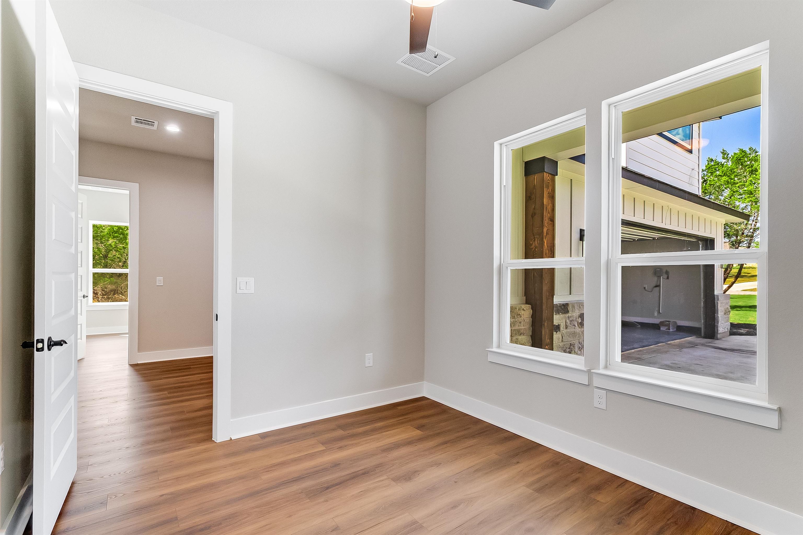 179 Rosebud Rnch Road Bertram, TX 78605 - Photo 20 of 28 wooden floor in an empty room with a window