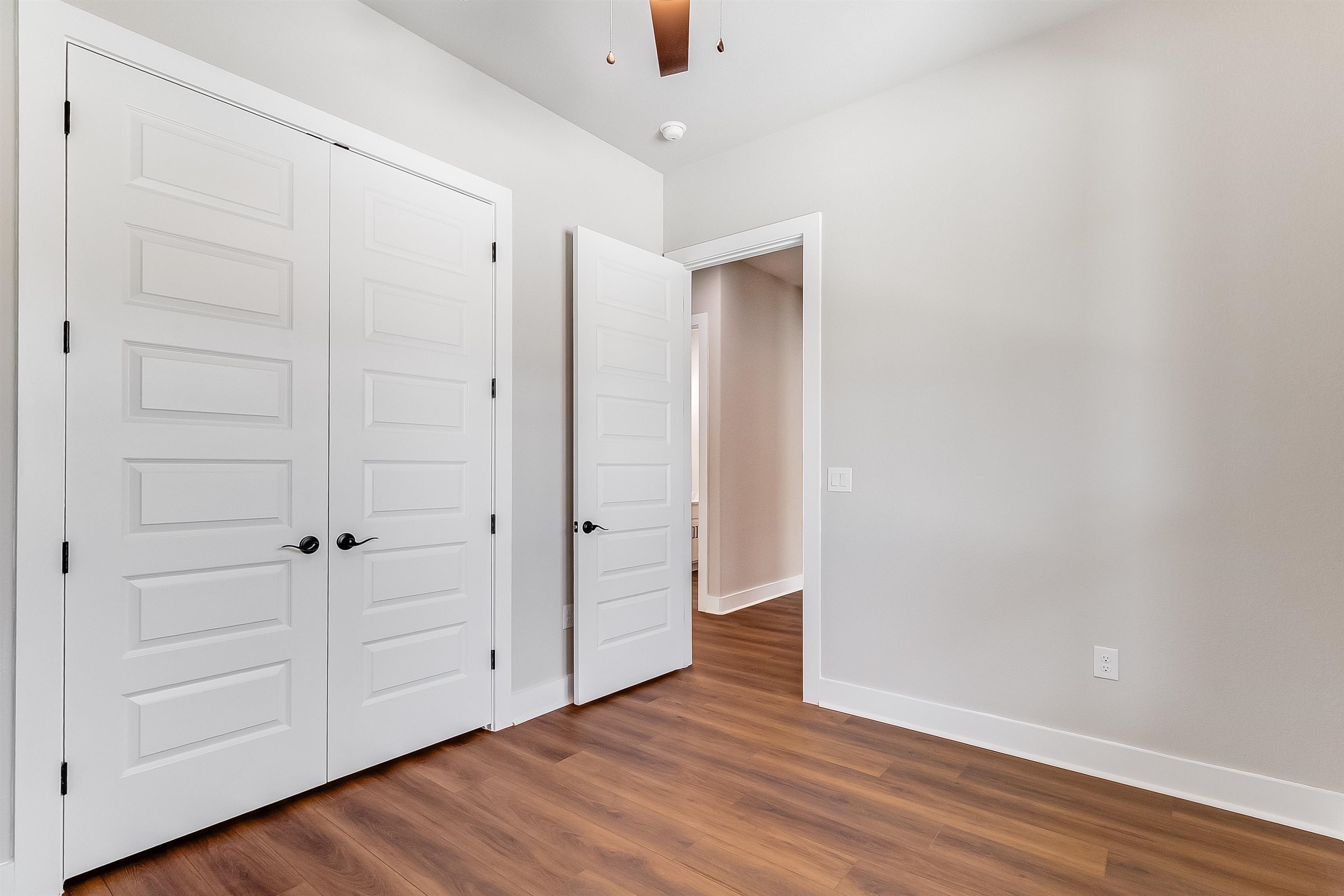 179 Rosebud Rnch Road Bertram, TX 78605 - Photo 21 of 28 a view of an empty room with wooden floor