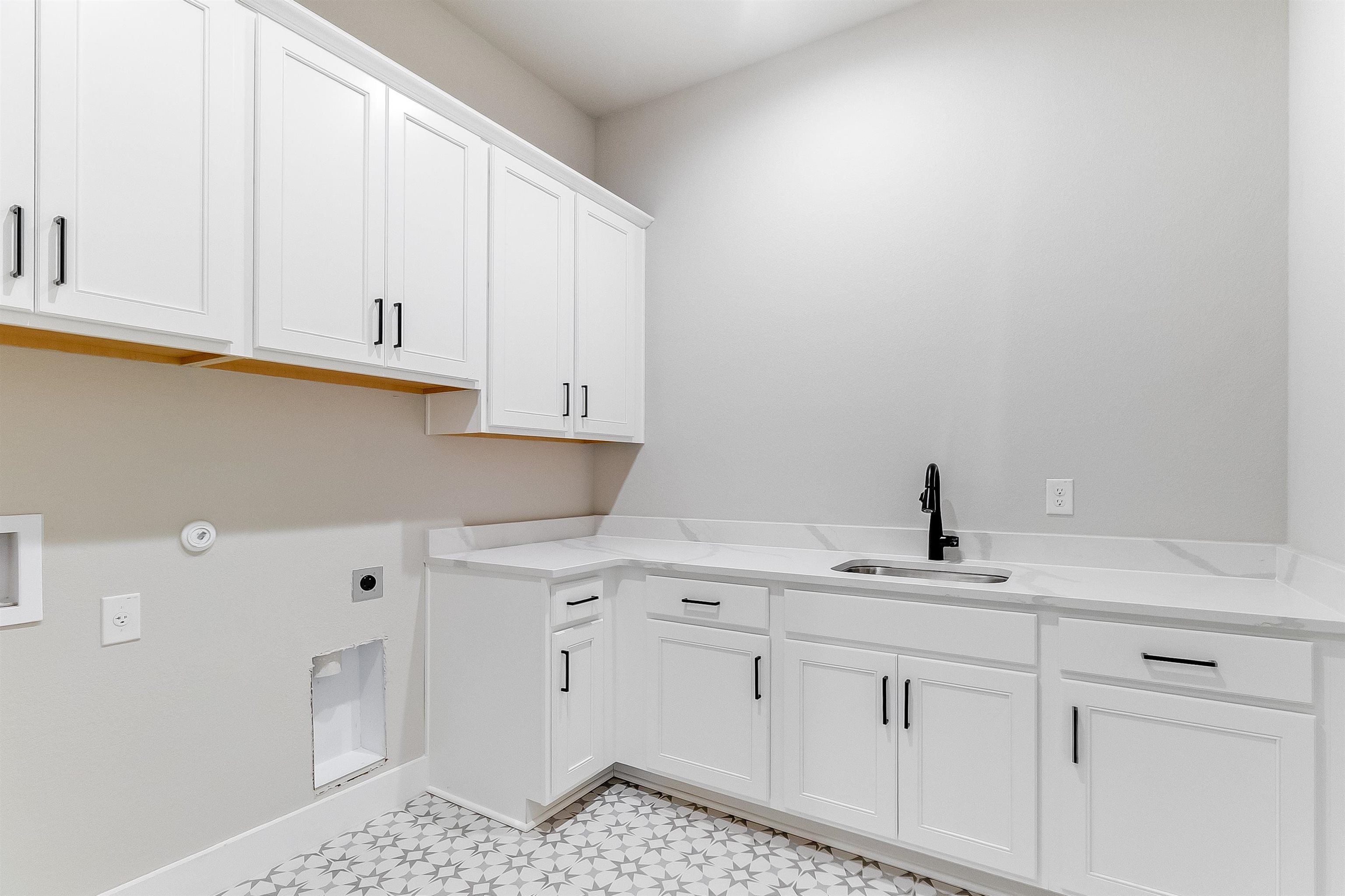 179 Rosebud Rnch Road Bertram, TX 78605 - Photo 22 of 28 a kitchen with cabinets appliances and a sink