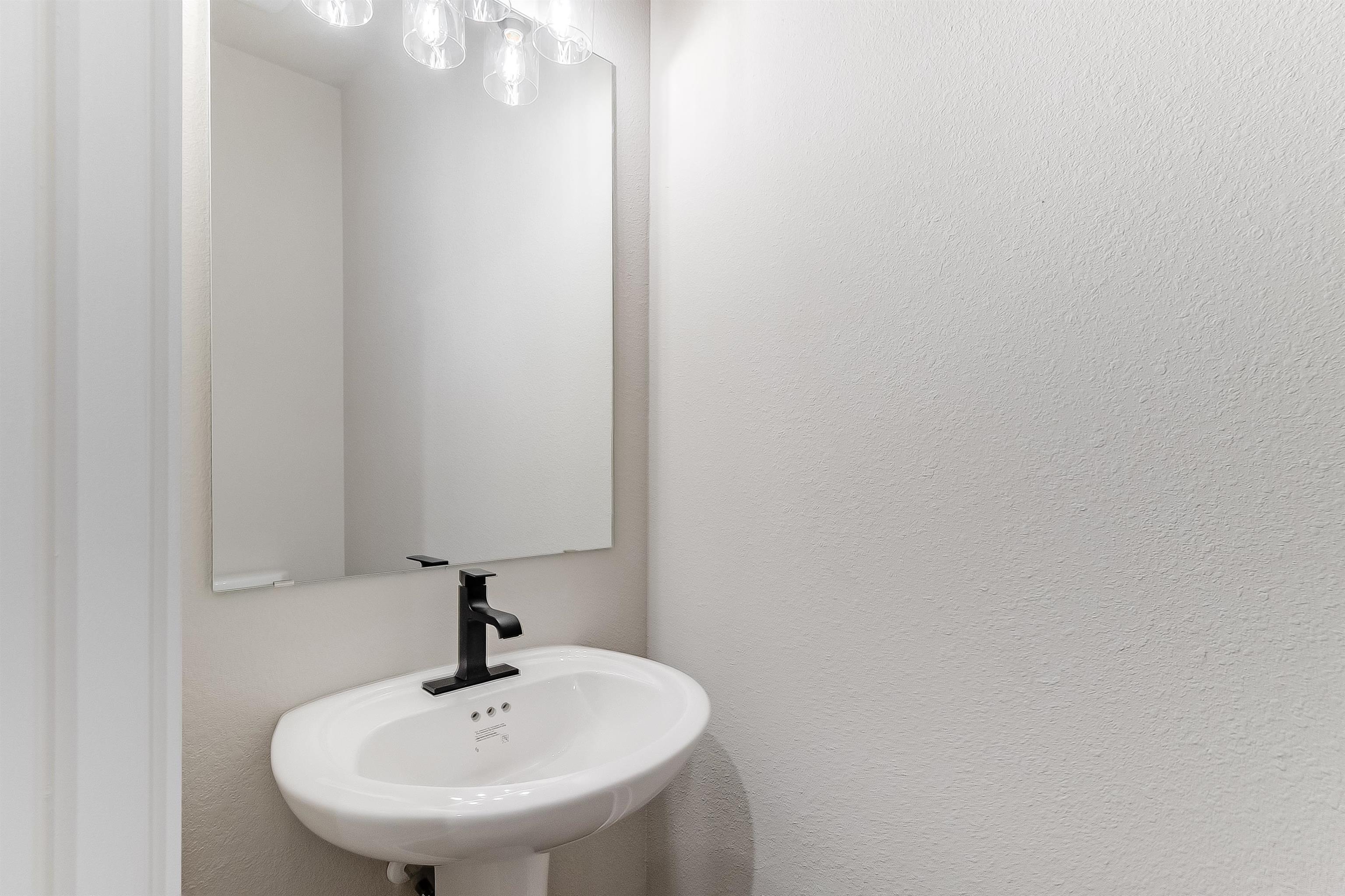 179 Rosebud Rnch Road Bertram, TX 78605 - Photo 25 of 28 a bathroom with a sink and a mirror