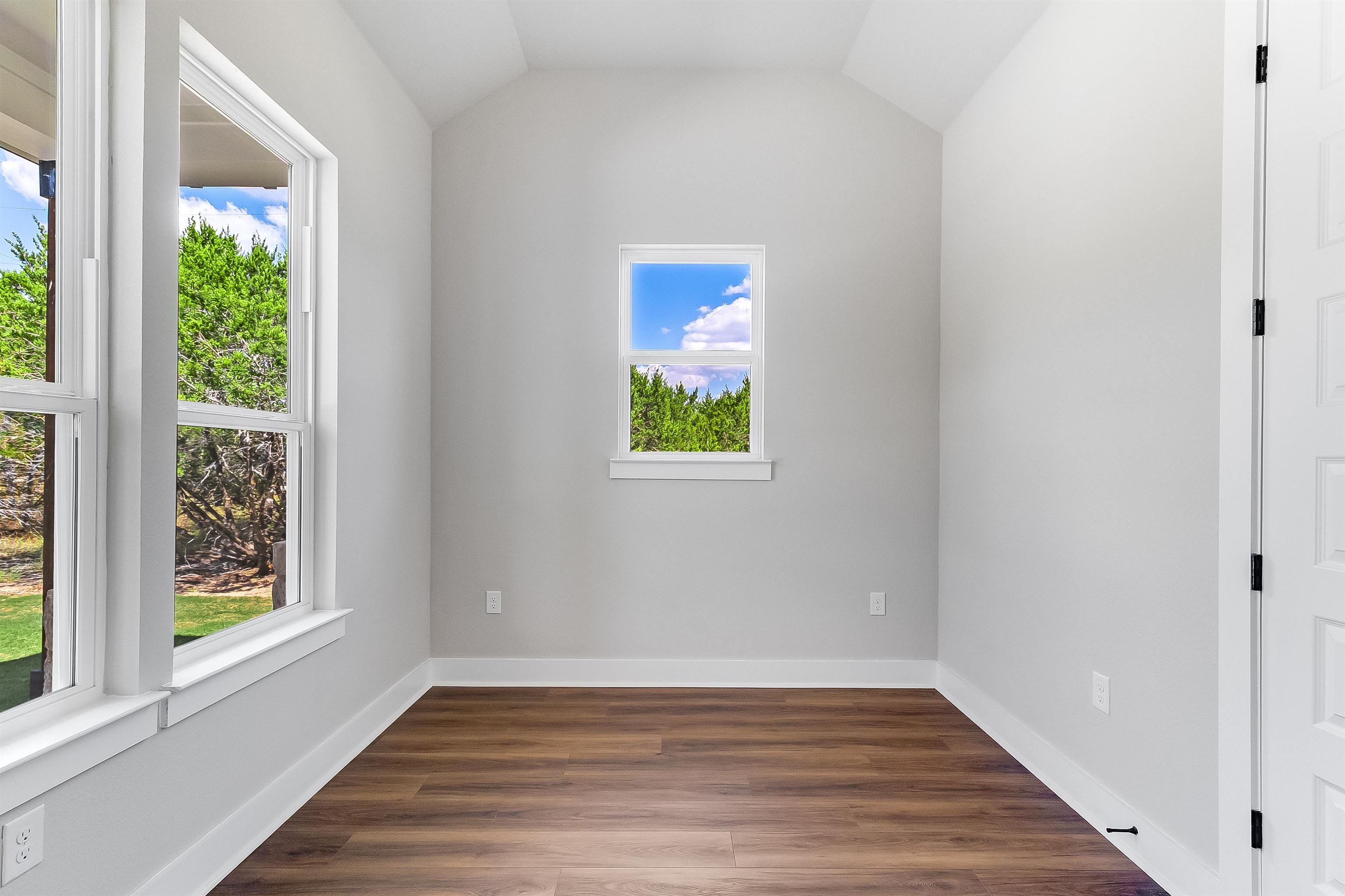 179 Rosebud Rnch Road Bertram, TX 78605 - Photo 3 of 28 a view of an empty room with wooden floor and a window