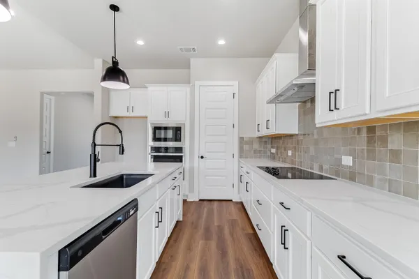 a kitchen with a sink and cabinets