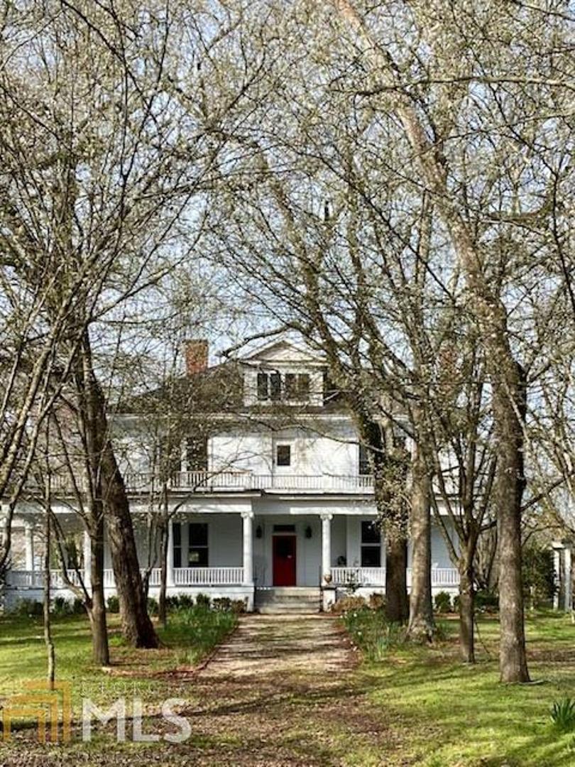 403 West Main Street Lexington, GA 30648 - Photo 1 of 1 a front view of a house with a large trees