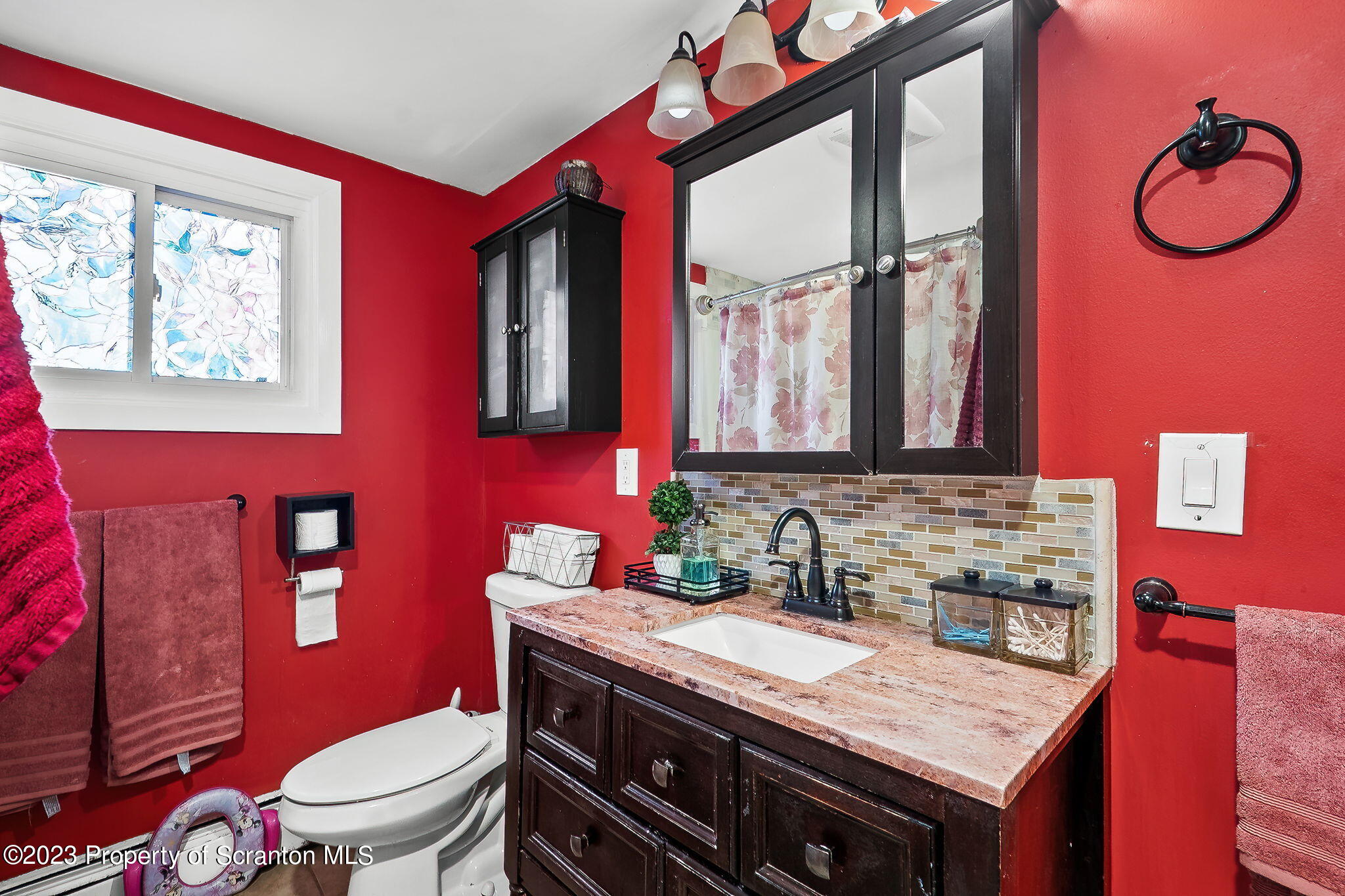 1023 Mark Avenue Scranton, PA 18510 - Photo 11 of 23 a bathroom with a granite countertop toilet sink and mirror
