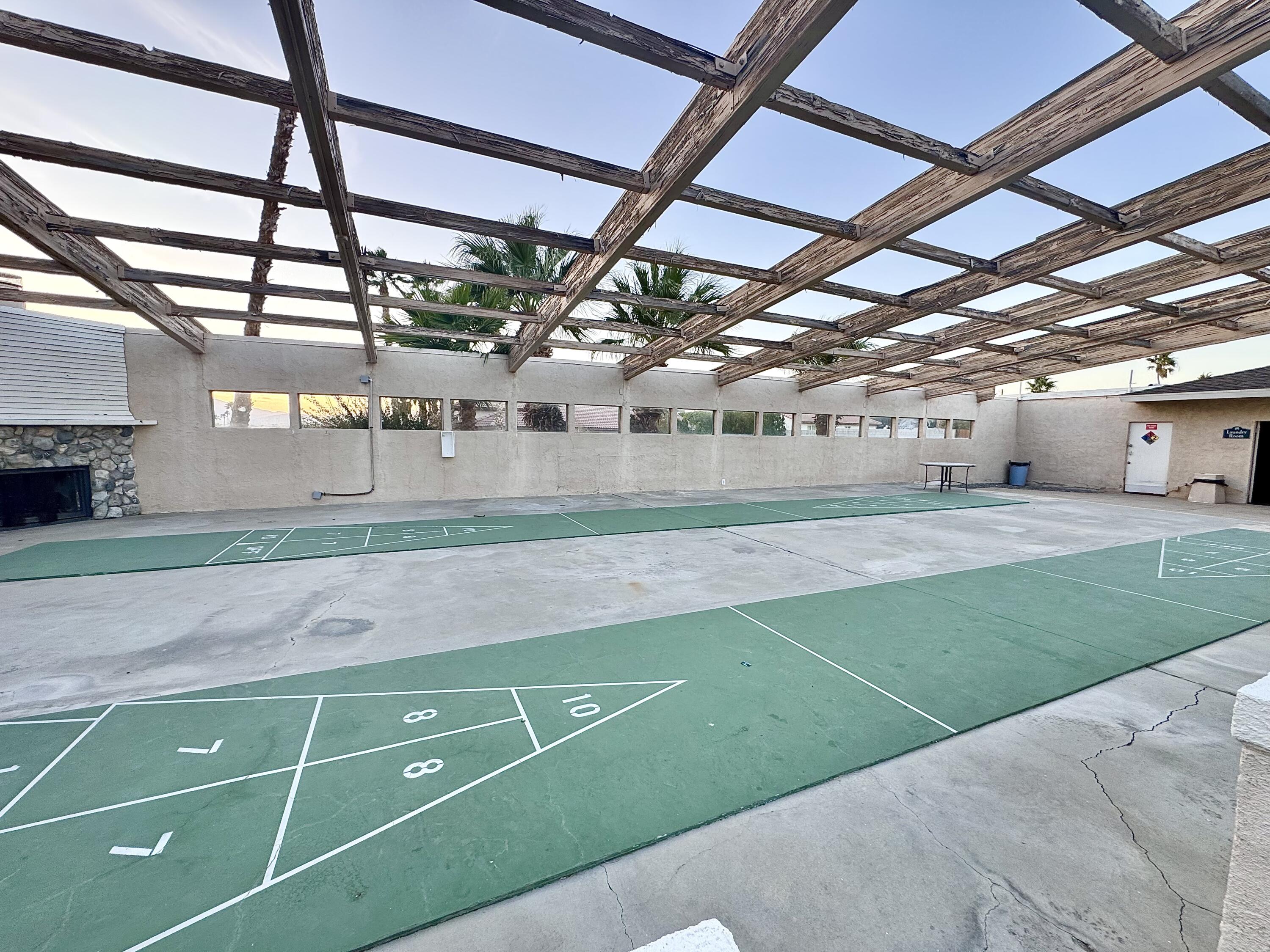 15500 Bubbling Wells Road, Unit 243 Desert Hot Springs, CA 92240 - Photo 36 of 39 a green field with trees in the background