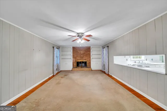 a view of a livingroom with a ceiling fan and window