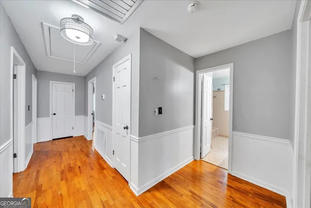 a view of a room with wooden floor and hallway