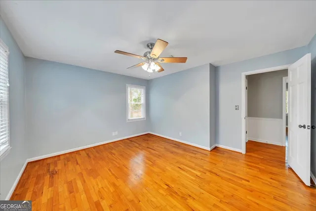 a view of a big room with closet and a chandelier fan
