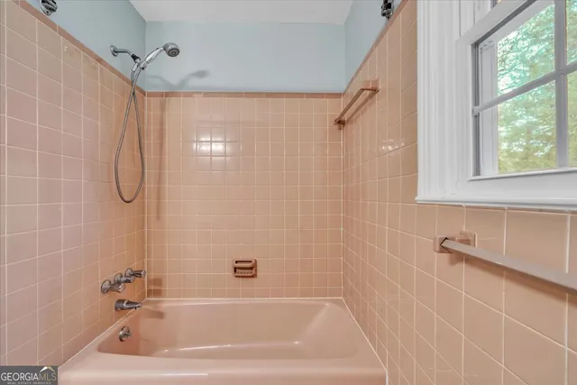 a bath tub sitting next to a shower