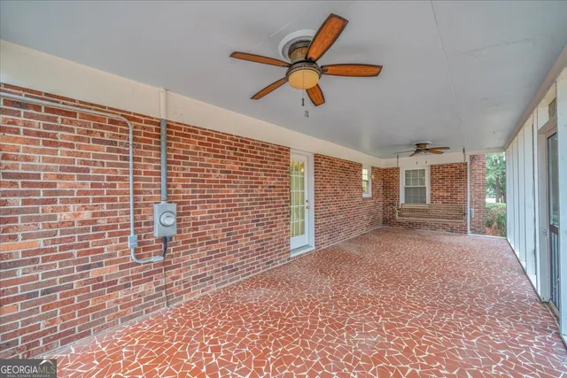 a view of a livingroom with a ceiling fan and window