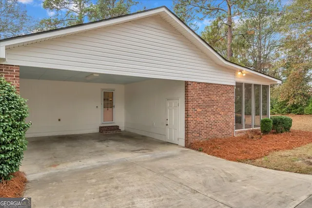 a view of a house with a backyard and garage