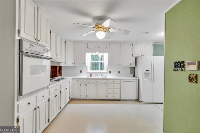 a kitchen with white cabinets