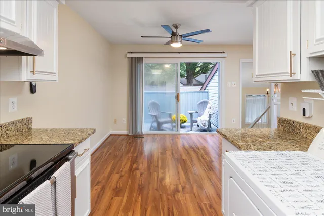 a kitchen with granite countertop a oven a counter space and a sink