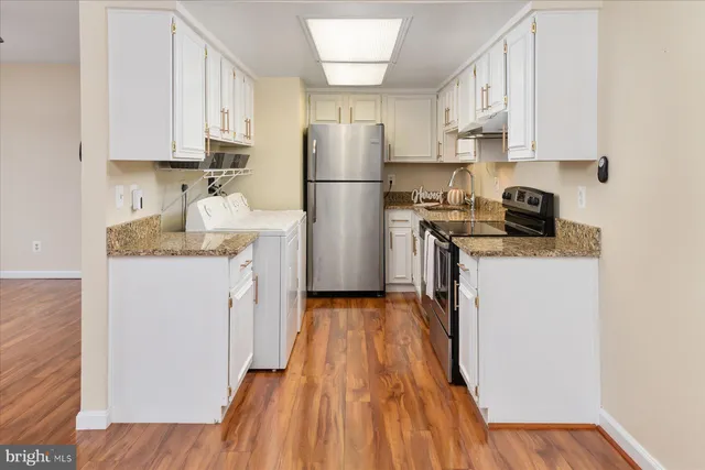 a kitchen with a refrigerator a stove top oven a sink and dishwasher