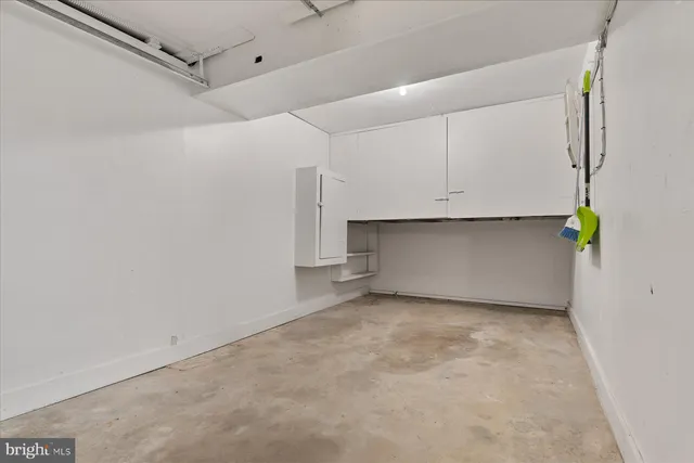 a view of a kitchen with white cabinets and a wooden floor