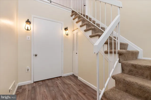 a view of entryway and hall with wooden floor